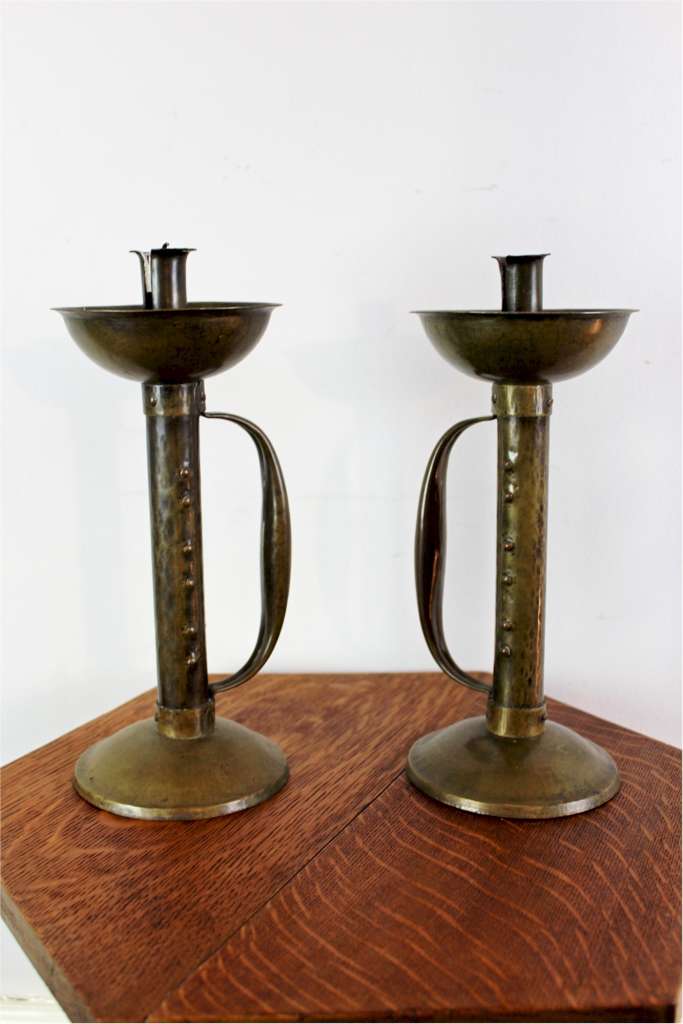 Pair of arts and crafts movement brass candlesticks