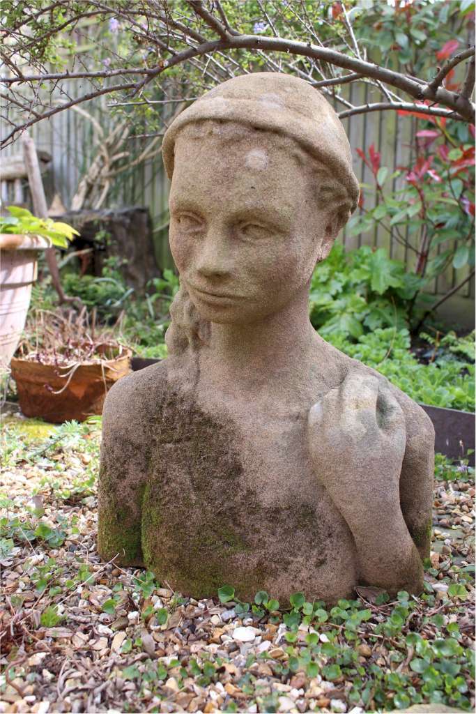 Garden statue in sandstone of  an Island girl