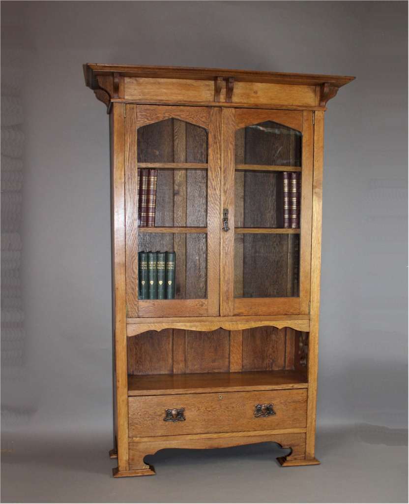 Arts and Crafts cottage oak glazed bookcase with pierced cutouts