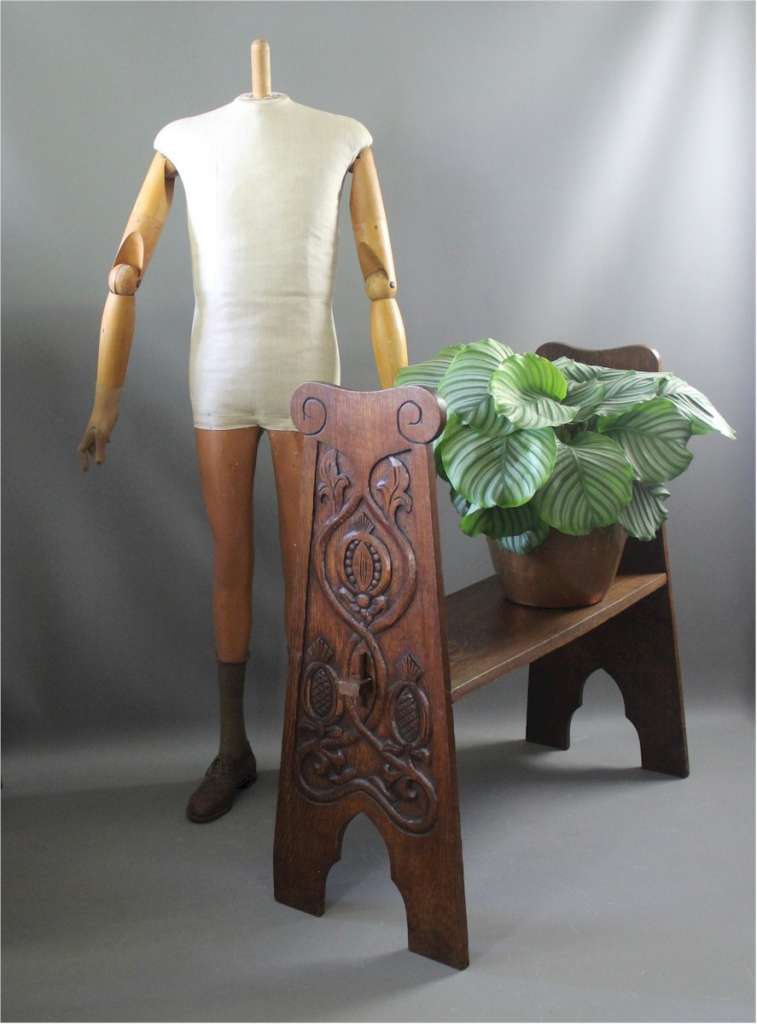 Arts and Crafts oak bench with carved pomegranates