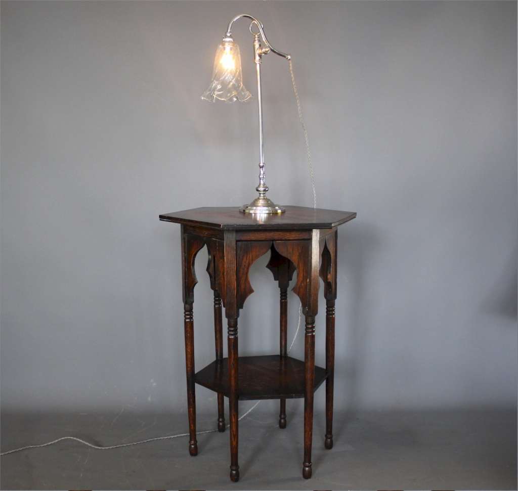 Elegant Edwardian adjustable table lamp with clear glass shade.