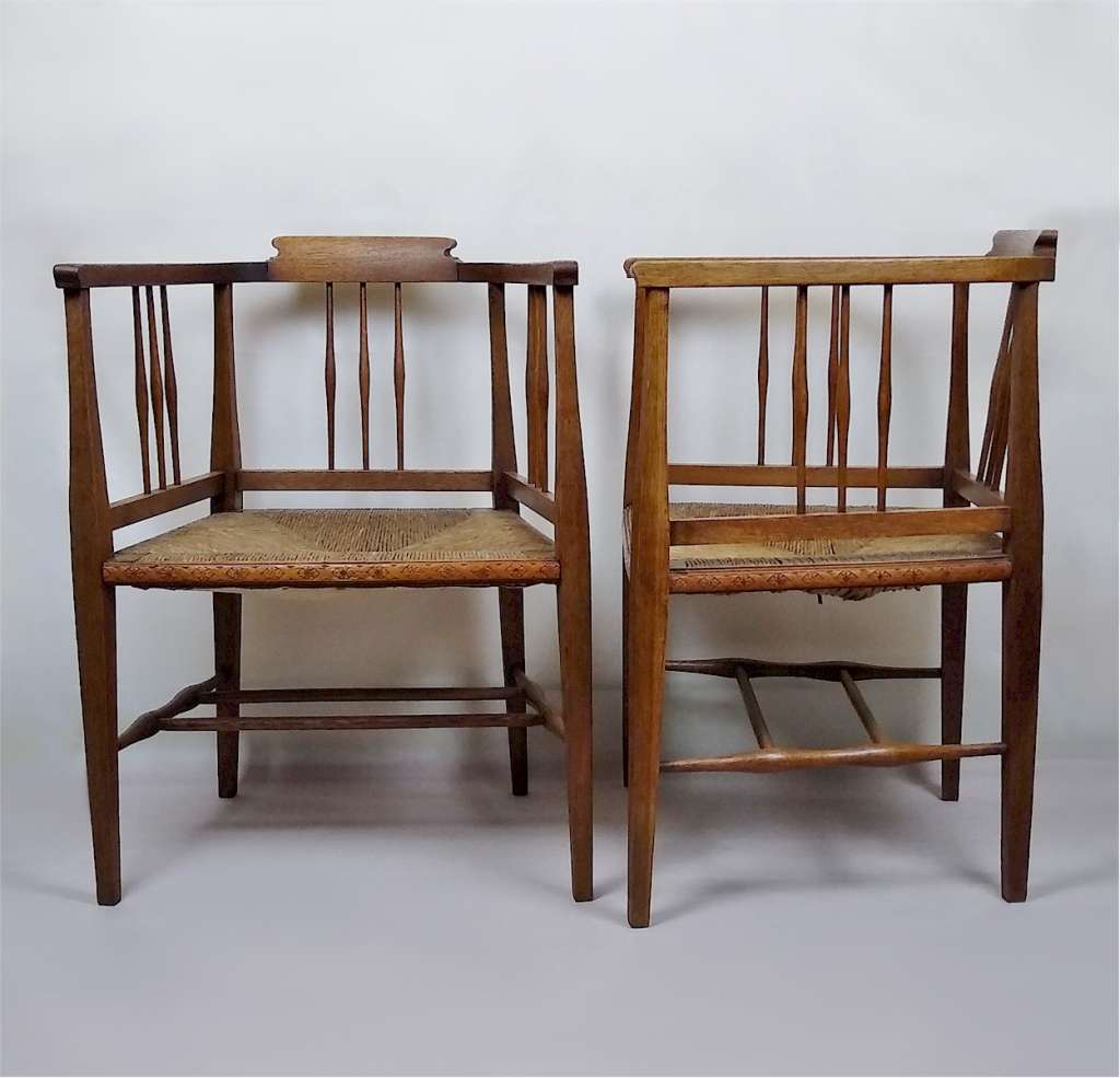 Pair of arts and crafts tub chairs in oak