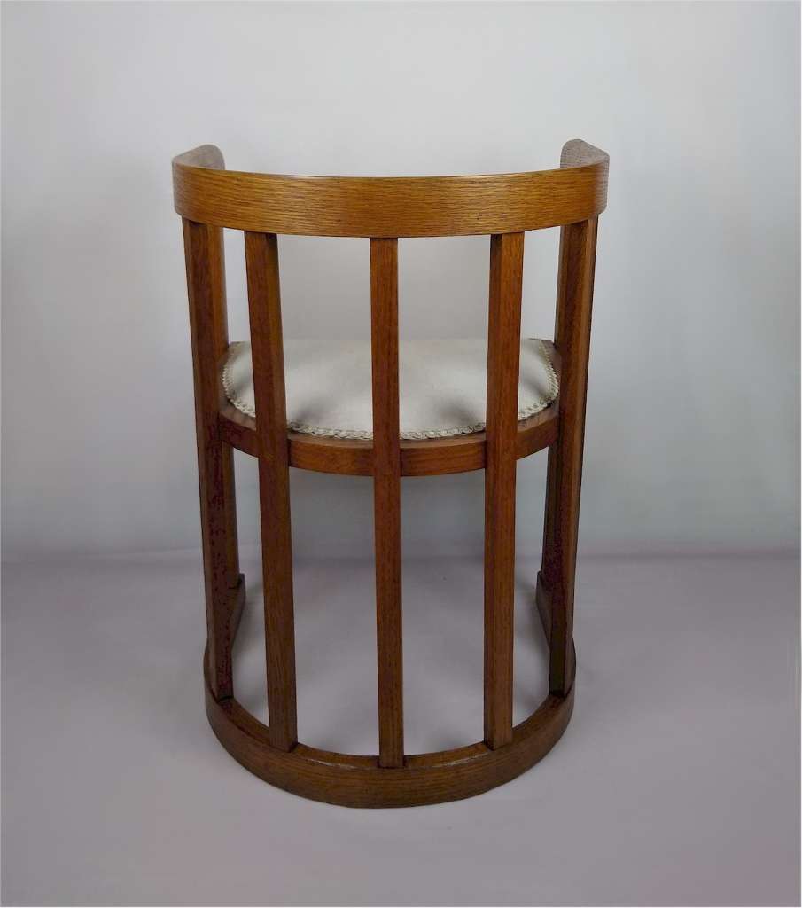 Arts and crafts barrel shaped armchair in oak