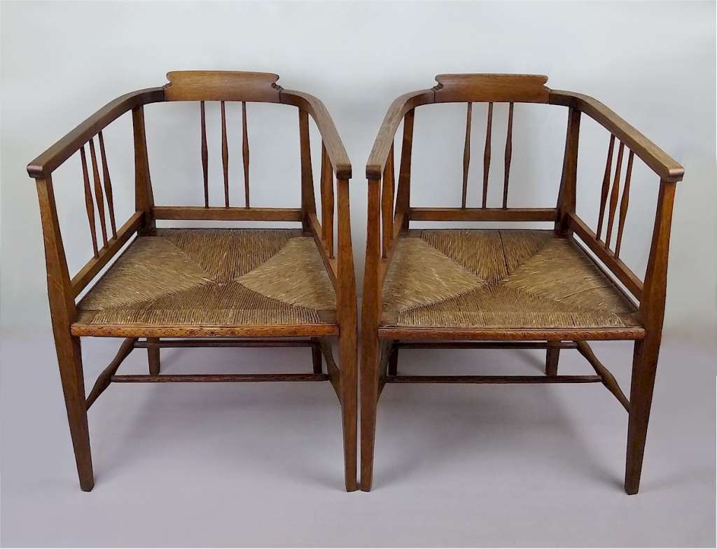 Pair of arts and crafts tub chairs in oak