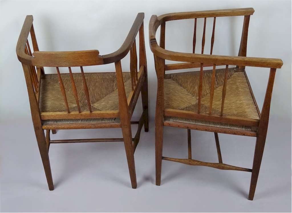 Pair of arts and crafts tub chairs in oak