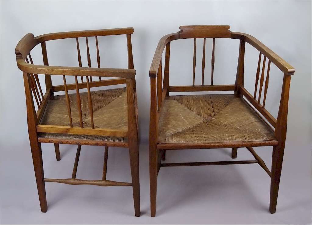 Pair of arts and crafts tub chairs in oak