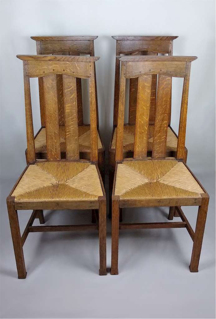 Arts and crafts oak dining chairs by Liberty