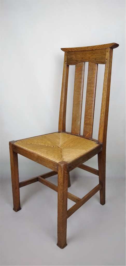 Arts and crafts oak dining chairs by Liberty