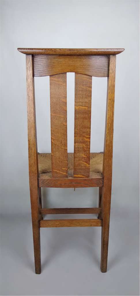 Arts and crafts oak dining chairs by Liberty