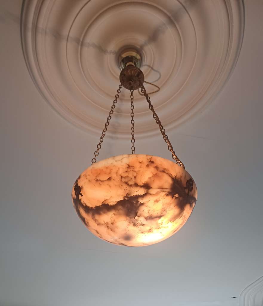 Alabaster ceiling shade with pinkish grain.