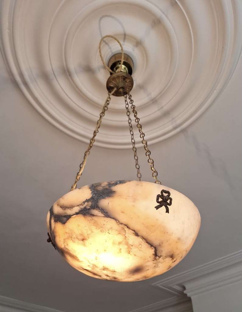 Alabaster ceiling shade with pinkish grain.