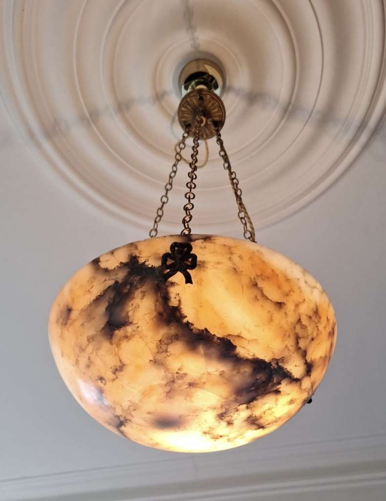Alabaster ceiling shade with pinkish grain.
