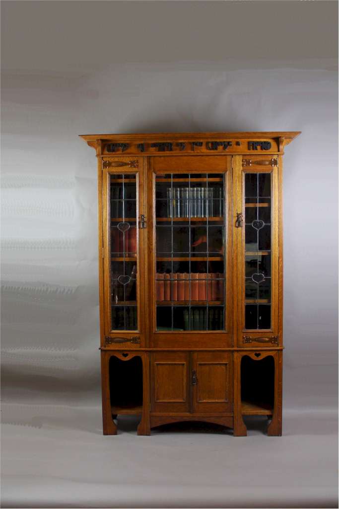 Arts and Crafts oak glazed bookcase with Motto