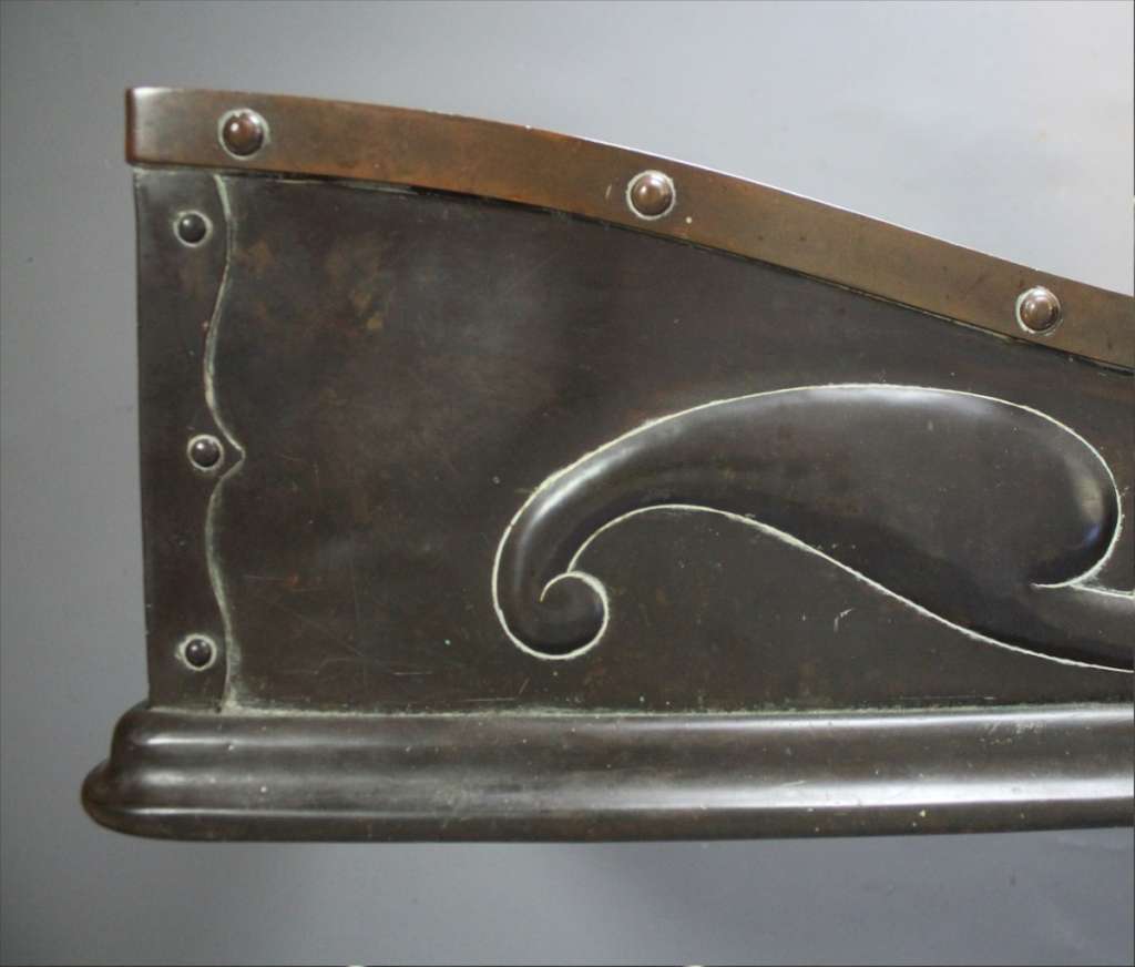 An Arts and Crafts bronze and copper fender