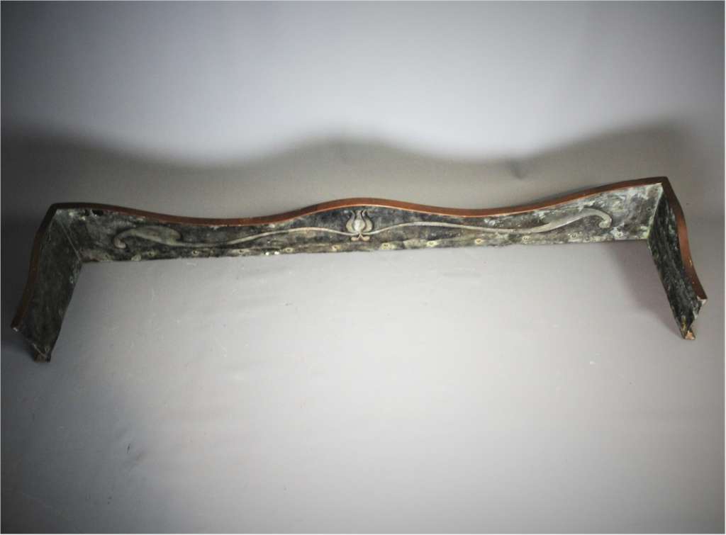 An Arts and Crafts bronze and copper fender