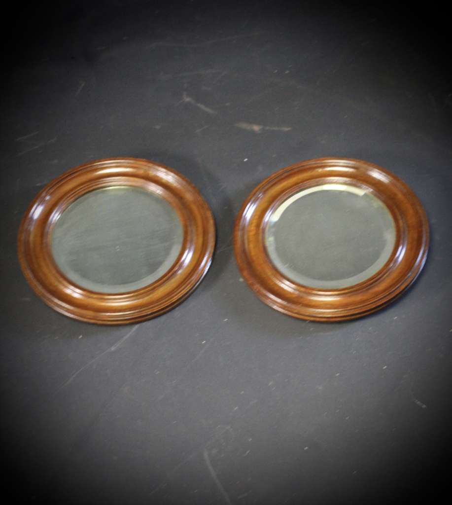 pair of oak framed circular mirrors