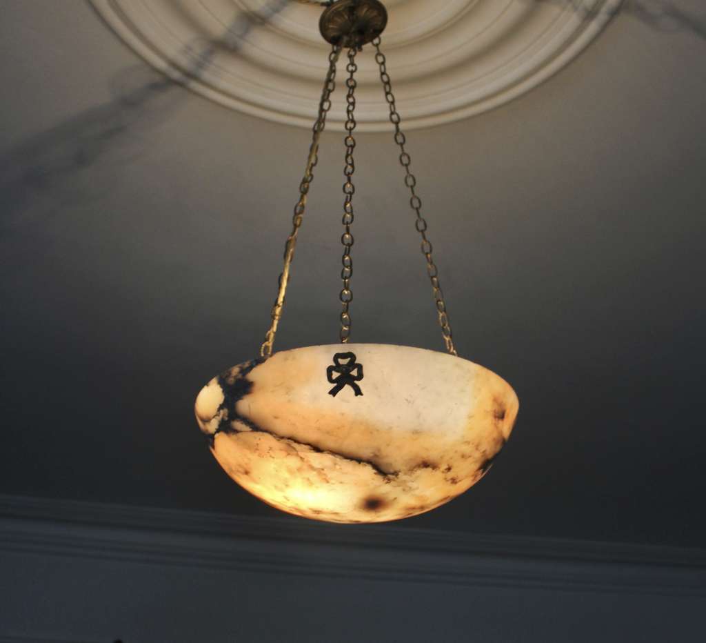 Alabaster ceiling shade with pinkish grain.