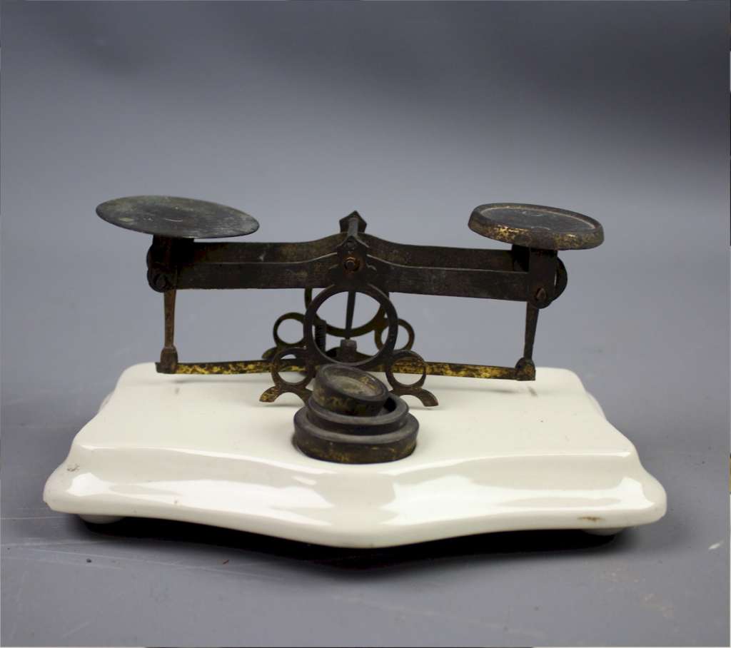 Ceramic and brass postal scales.