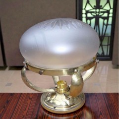 Small domed ceiling light in hammered brass