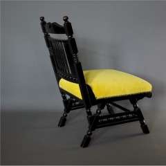Aesthetic Movement Ebonised fireside chair.