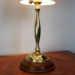 Arts and Crafts brass table lamp on wooden plinth.