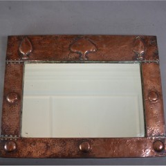 Arts and crafts copper mirror with raised spear motifs
