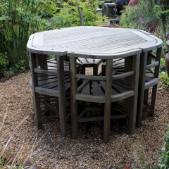 Rare teak garden set of table and six wrap round chairs retailed by Heals made by Hughes Bolckow