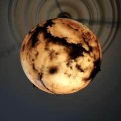Alabaster ceiling shade with pinkish grain.