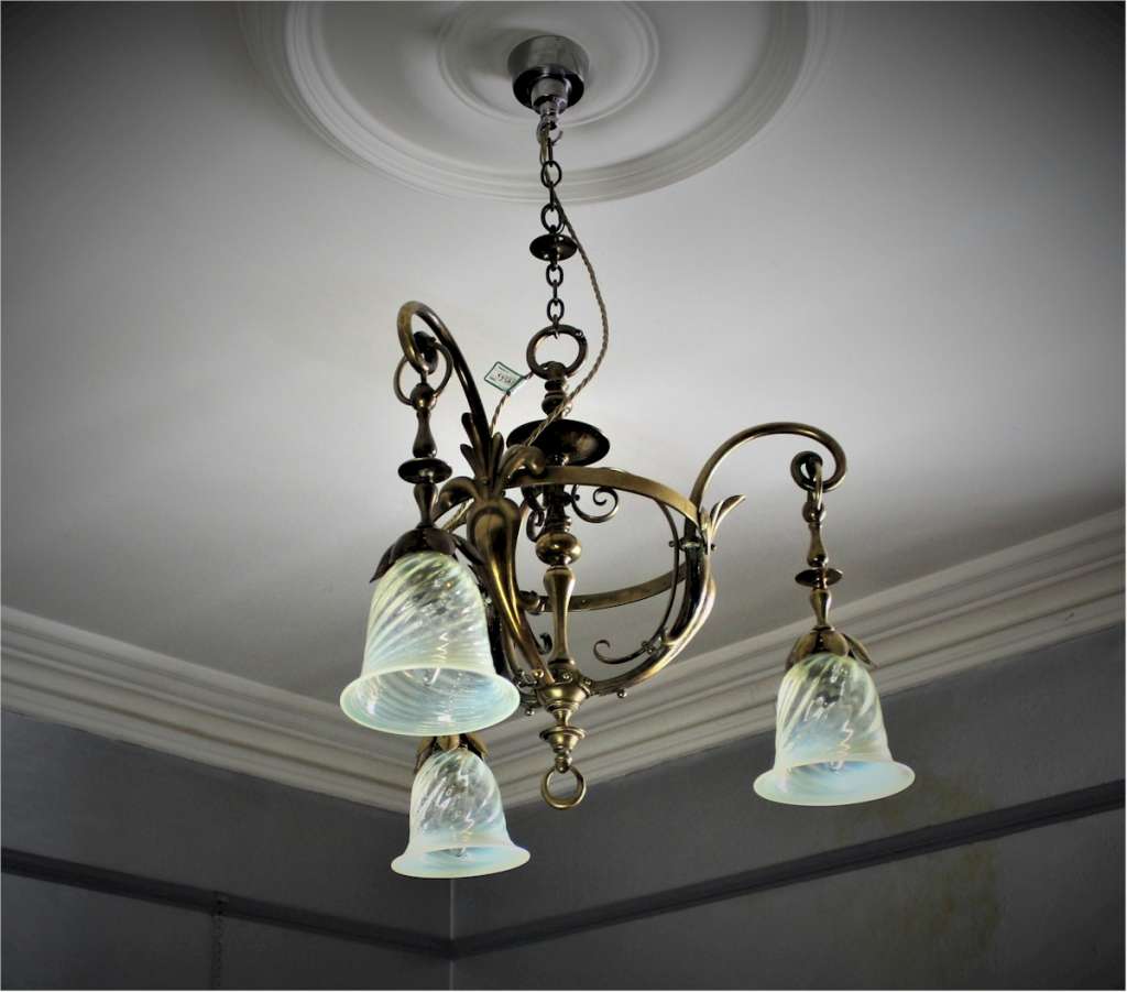 Arts and crafts brass hanging lamp with vaseline shades.